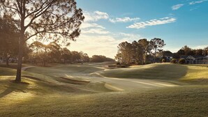 A golf course with sand bunkers, trees, and a clear sky. - Southern Dunes- Lake View Villa -Private Pool (Haines City)