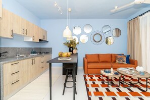 Una cocina moderna con comedor, un sofá y un tapete estampado.
