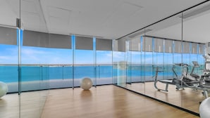 A modern gym with exercise equipment and a large window overlooking the sea. - Tizate Sea Sanctuary by Monyxbnb (La Cruz de Huanacaxtle)