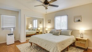 A bedroom with a bed, bedside tables, a ceiling fan, and a window with blinds. - 2 Mi to Ocean: Pet-Friendly Imperial Beach Retreat (Imperial Beach)