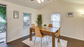 A dining area with a wooden table, four chairs, a ceiling fan, and a potted plant. - 2 Mi to Ocean: Pet-Friendly Imperial Beach Retreat (Imperial Beach)