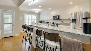 A modern kitchen with white cabinets, stainless steel appliances, and a granite countertop. - Near Rev & Civil War History Museums! Camden Home (Camden)