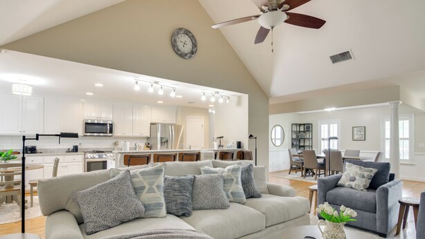 A spacious living area with a large sofa, a coffee table, and a dining area in the background. - Near Rev & Civil War History Museums! Camden Home (Camden)