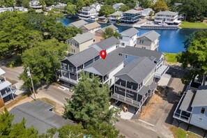 An aerial view of a residential area with houses, a dock, and a body of water. - Luxury Beach House, Elevator, Golf Cart & Grill! (Myrtle Beach)