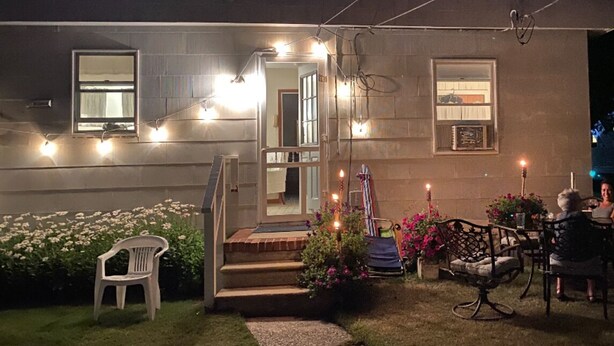 A residential building with a front porch, steps, and outdoor seating area. - Victory Bungalow - 2 bed / 1.5 bath - AC-Affordable-Clean - Sleeps 6+ Avalon, NJ (Avalon)