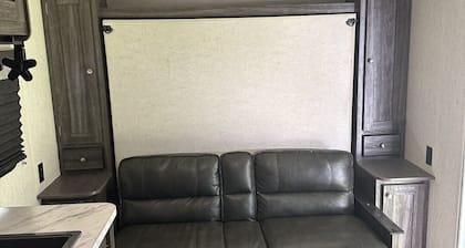 Cozy camper with queen Murphy bed, bunks, and dinette conversion bed.