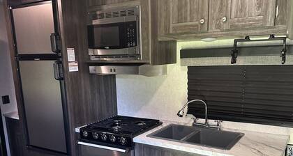 Cozy camper with queen Murphy bed, bunks, and dinette conversion bed.