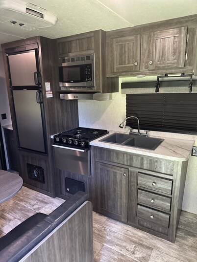 Cozy camper with queen Murphy bed, bunks, and dinette conversion bed.