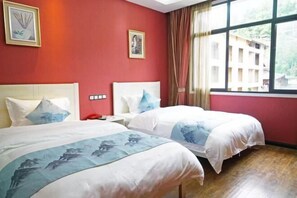 A hotel room with two beds, red walls, a large window with curtains, and artwork on the walls. - Xi'an Inn (Zhangjiajie Zixia Temple) (Zhangjiajie)