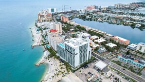 A coastal hotel with multiple floors, a beach, and a marina.