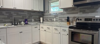 Modern 3-bedroom house with large yard, screen rooms and arcade machine