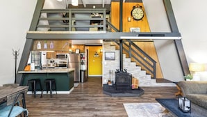 A loft-style living space with a kitchen, dining area, and a fireplace.