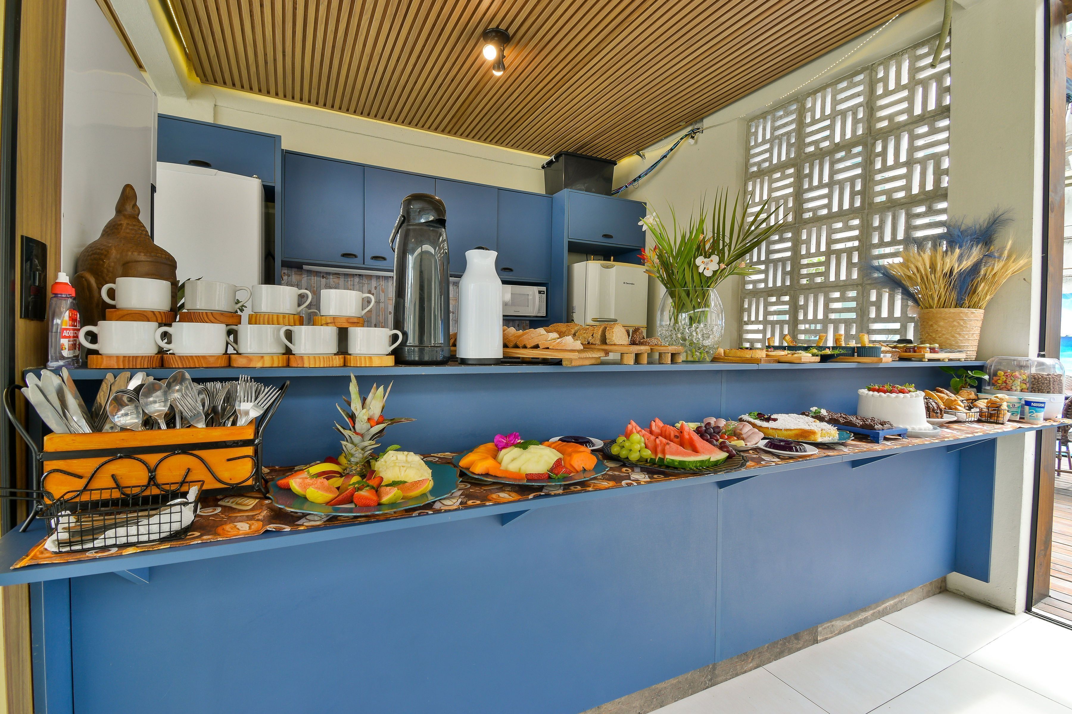 A breakfast buffet with various food items, utensils, and a coffee station.