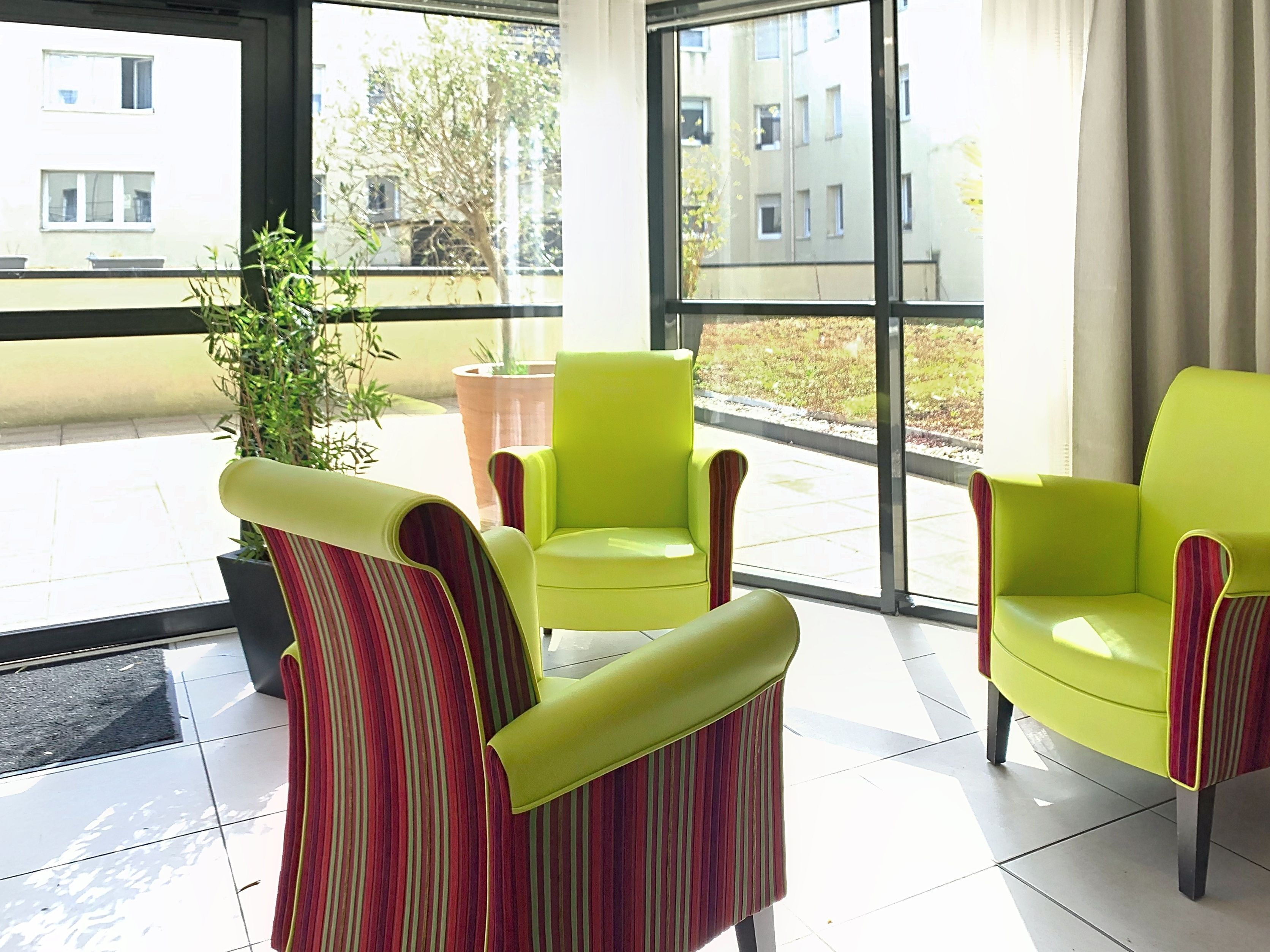 A modern indoor seating area with chairs and a potted plant.
