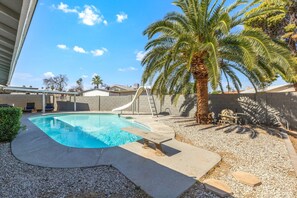 A swimming pool with a slide, palm trees, and a covered seating area. - Exclusive Residence in Glendale (Glendale)
