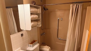 A bathroom with a bathtub, toilet, sink, and towel rack.