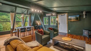 A cozy living room with a sofa, chairs, a coffee table, and a fireplace. - Packwood: Chalet + Nest (Packwood)