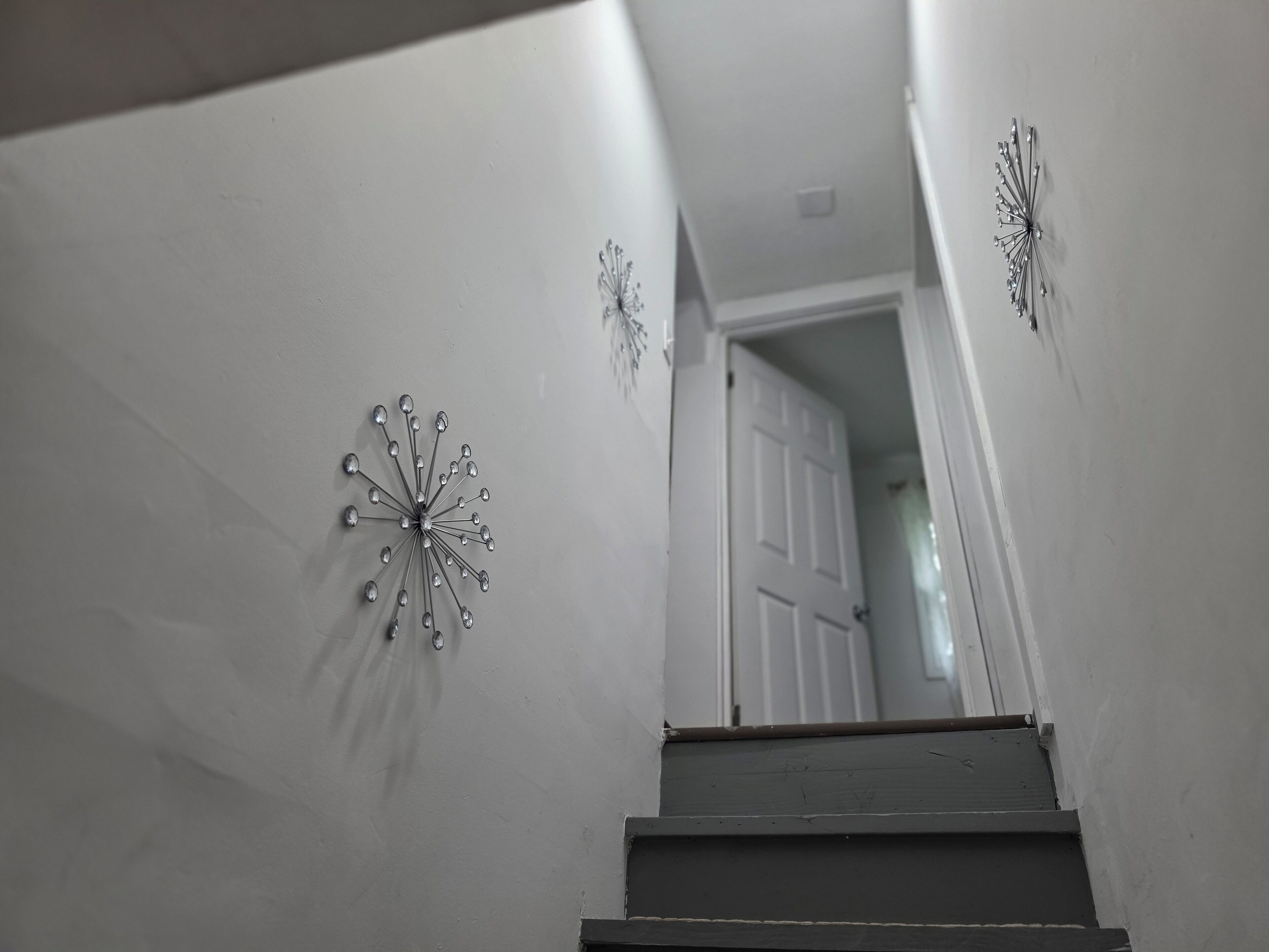 Un escalier avec une porte blanche en haut.