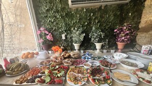 A buffet table with various food items and decorations.