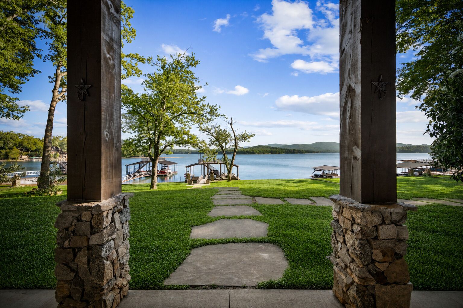 A stone pathway leading to a gazebo overlooking a lake with dock structures.