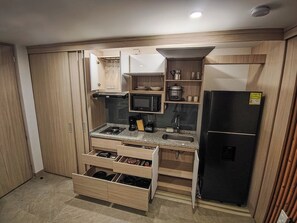 Fridge, microwave, coffee/tea maker, cookware/dishes/utensils