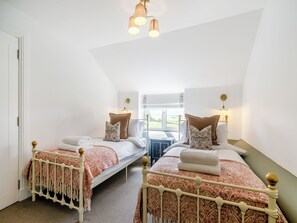 A bedroom with two beds, a window, and a ceiling light fixture. - 3 bedroom accommodation in Kirkton of Lethendy (Kirkton of Lethendy)