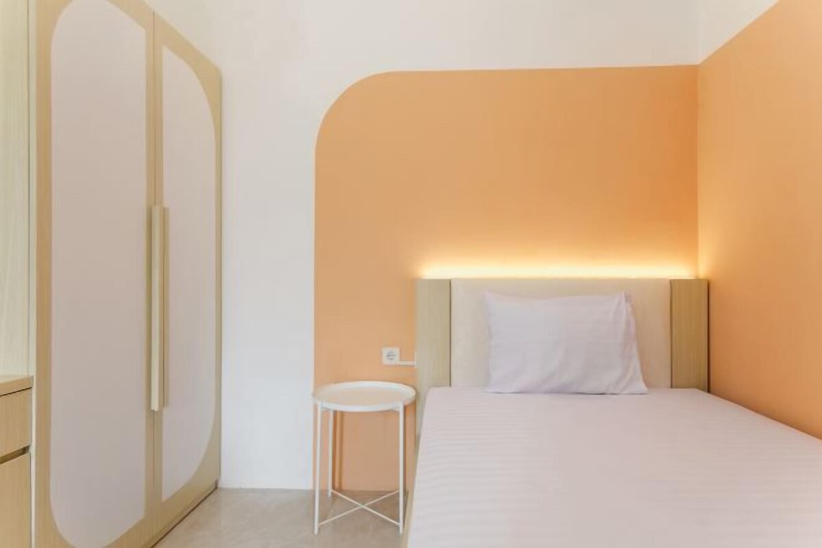 Une chambre à coucher avec un lit, une table de chevet et une armoire.