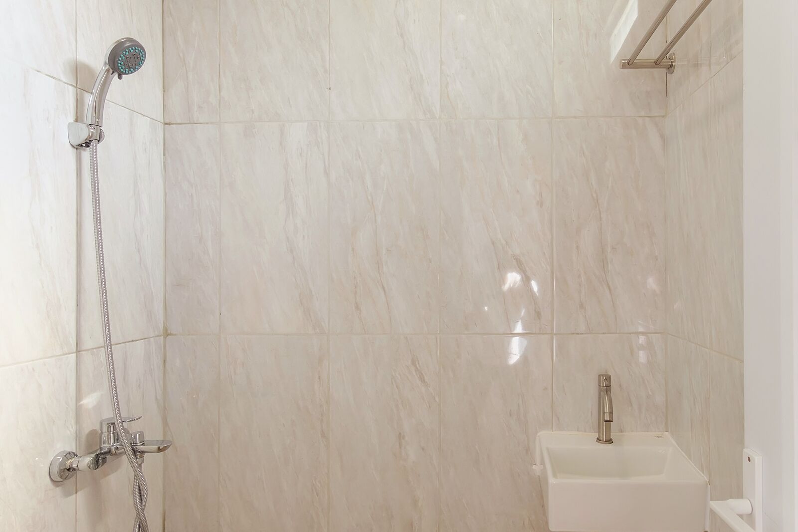 A bathroom with a shower, a sink, and a toilet.