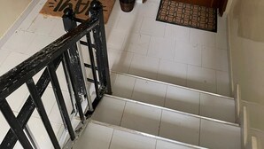 A staircase with wooden doors labeled "1ERE A1" and "1EME A2". - Hidden Gem in Ouakam [Mamelles] (Dakar)