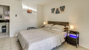 A bedroom with a bed, bedside tables, a ceiling fan, artwork on the wall, and a window. - Suburban Home By Arthur Storey Park & HCA Houston! (Houston)
