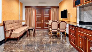 A hotel lobby with a sofa, chairs, a TV, and a marble floor. - Nicecy Hotel & Apartment - Central Sai Gon (Ho Chi Minh City)