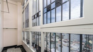 A room with large windows, a tiled floor, and a visible cityscape outside. - Nicecy Hotel & Apartment - Central Sai Gon (Ho Chi Minh City)