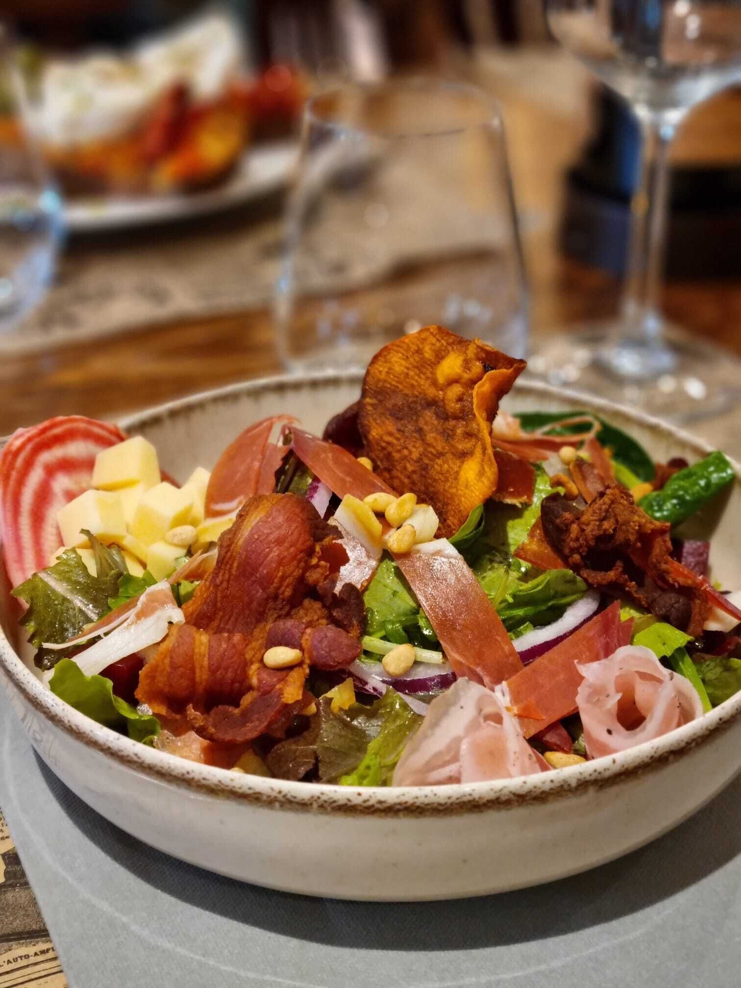 A bowl of salad with various ingredients.