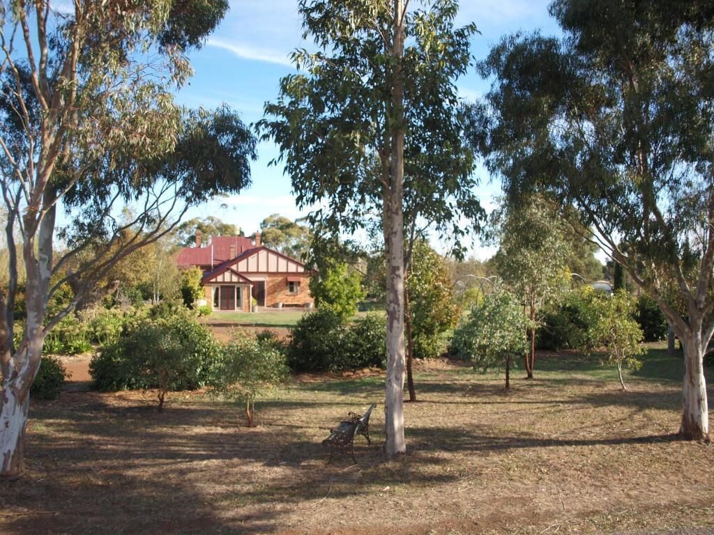 A house surrounded by trees and a grassy area.