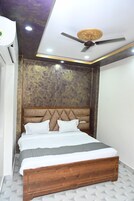 A bedroom with a wooden bed, a ceiling fan, and a textured wall.