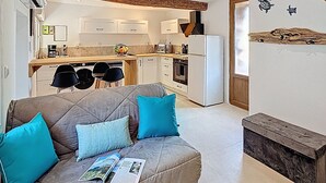 A modern living room with a sofa, a magazine, and a wooden bench.