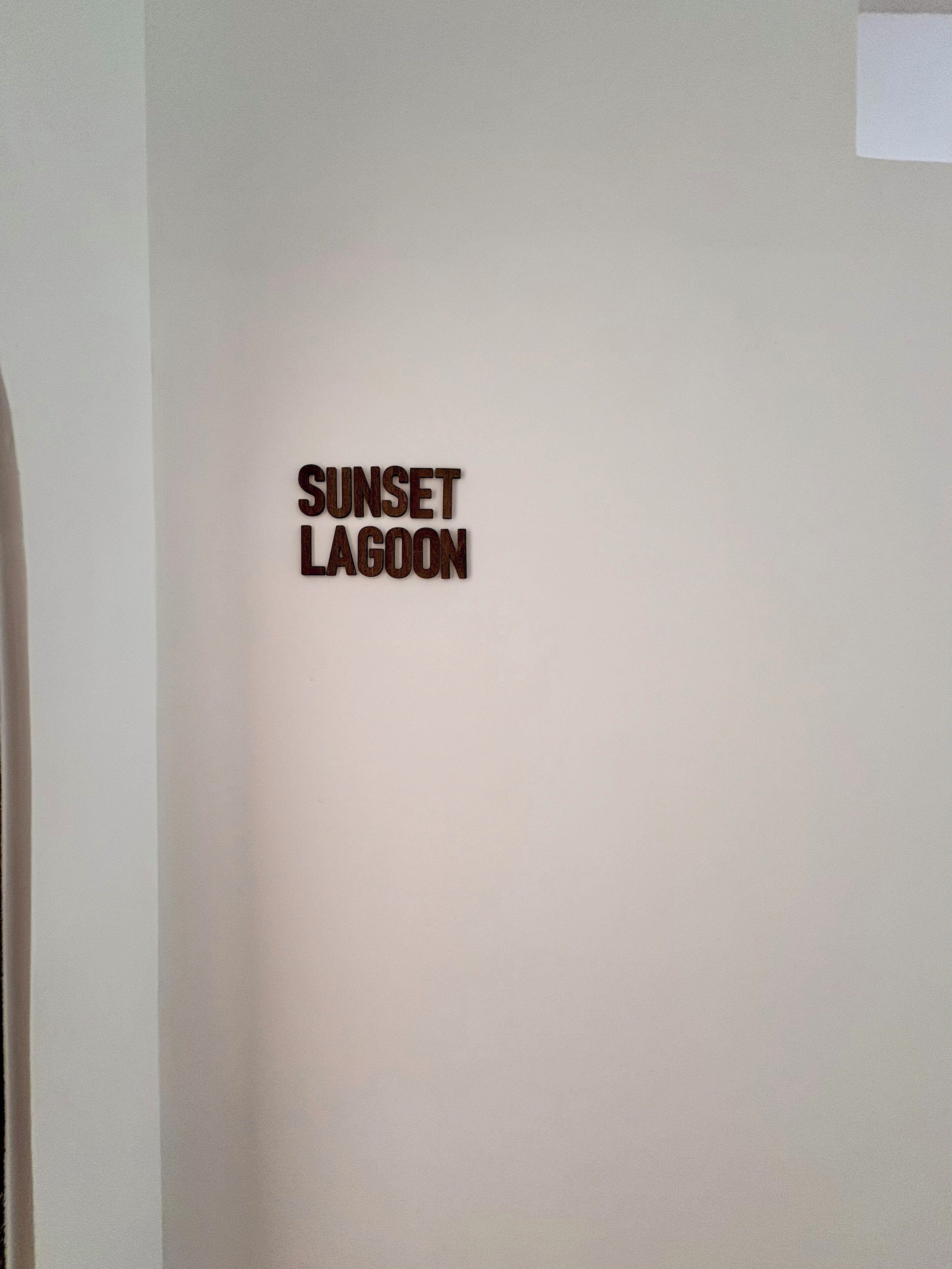 A wall with the text 'SUNSET LAGOON' indicating the name of a location or establishment.