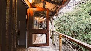 A wooden door leading to a covered porch with a view of dense greenery. - Way Out Wandi - Country charm in historic Wandiligong (Wandiligong)