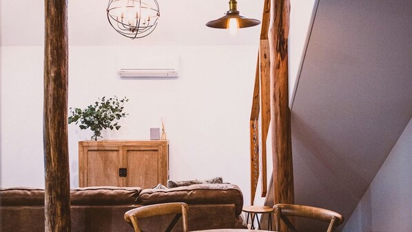A cozy room with a wooden cabinet, a plant, and a small table.