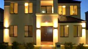 A two-story house with a central entrance, multiple windows, and a balcony. - Master retreat at Private Estate Near Perth CBD (Stirling)