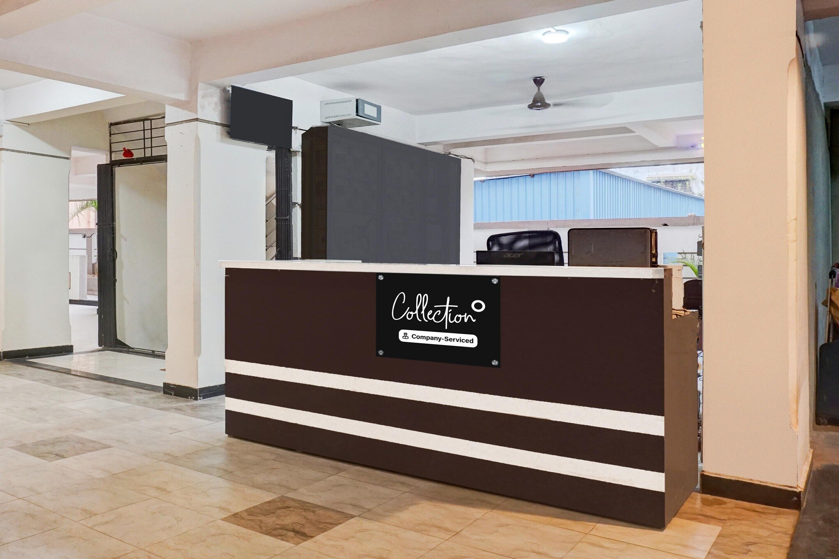 A reception desk with a sign indicating it is company-serviced.