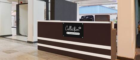 A reception desk with a sign indicating it is company-serviced.