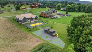 A large lodge with multiple buildings, a central courtyard, and a playground.