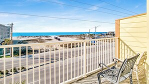 A balcony with a view of a beach and a road. - Kiran Terrace Quadplex by Liquid Life (Gulf Shores)