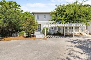 A two-story house with a covered porch and a gravel driveway. - Book 3 nts, get 1 free.Bike to Alys Beach,4 bikes, pool, deeded beach access. (Inlet Beach)