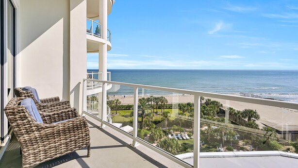 A balcony with wicker furniture and a view of the beach and ocean. - PH, Balcony, Lazy River, I-O Pools, Game Room, Spa, Beach, Luxury 2-2 Penthouse! (Galveston)