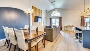 A modern living room with a dining table, sofa, and bar area. - 10 Mi to Disney: Family Retreat w/ Game Room! (Davenport)