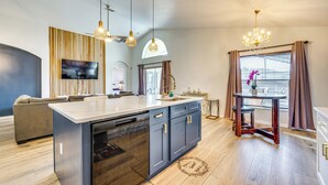 A modern kitchen with a central island, built-in dishwasher, and pendant lighting. - 10 Mi to Disney: Family Retreat w/ Game Room! (Davenport)