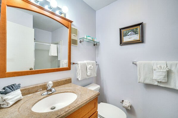 A bathroom with a sink, mirror, towel rack, and toilet. - Indoor & Outdoor Pool Access! Condo 3 Mi to Gsmnp (Gatlinburg)