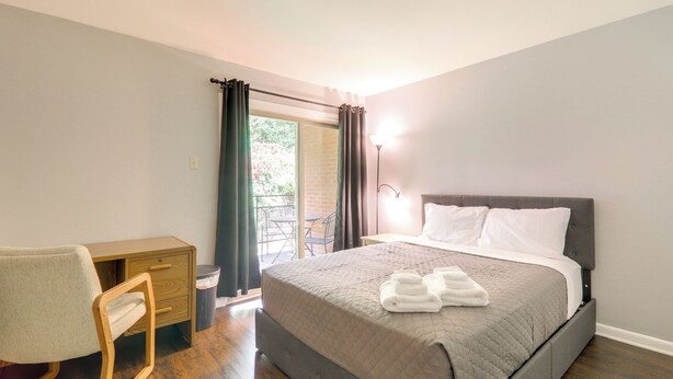 A bedroom with a bed, a desk, and a chair. - 1 Mi to Dtwn & Uga: Condo w/ Pool in Athens! (Athens)